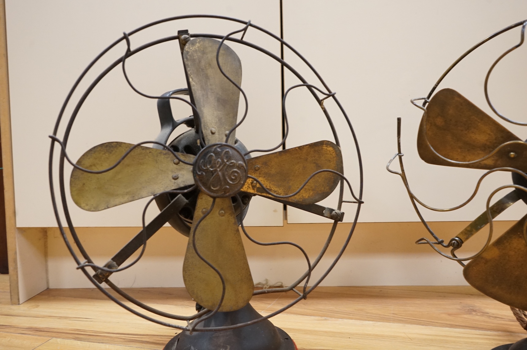 Two early 20th century electric fans, one by General Electric, 43cm high